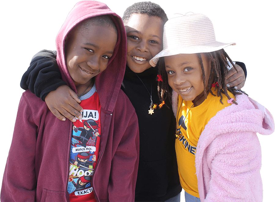 Three children smiling together at a Brighter Days youth program event in Dallas TX